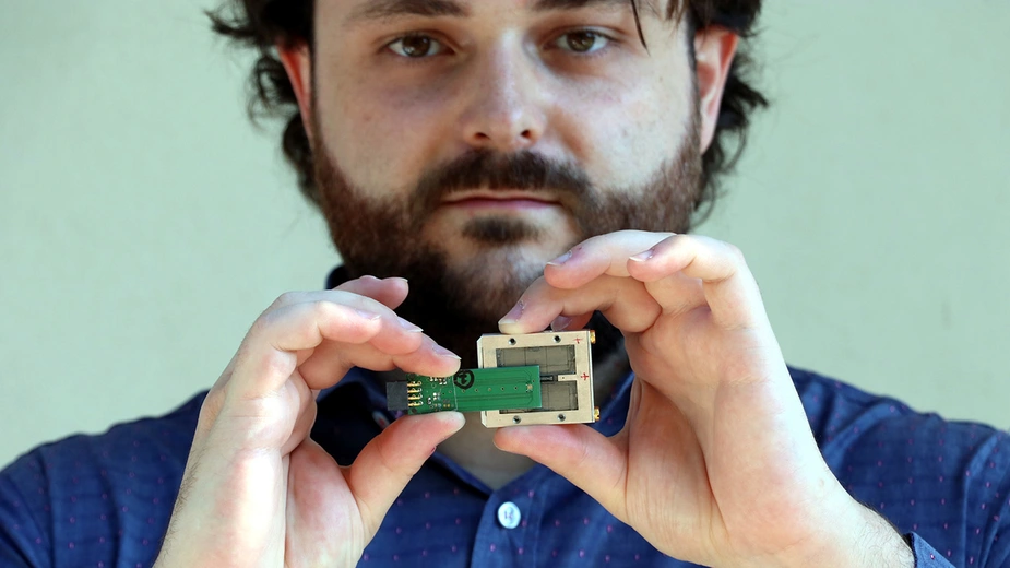 Der Physiker Michele Segantini demonstriert, wie kompakt der EPRoC-Sensor ist. © Luca Segantini